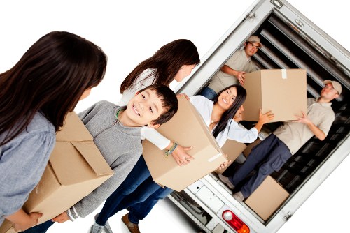 Removal team preparing for a move in Belsize Park with packed boxes and furniture