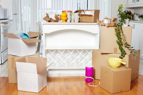 Professional removal team handling furniture and boxes in a Belsize Park street