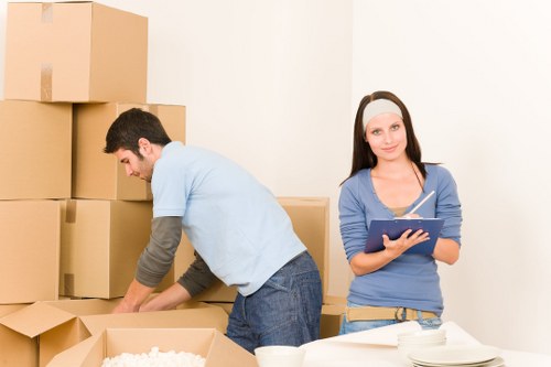 Professional movers protecting large furniture items during a Belsize Park removal